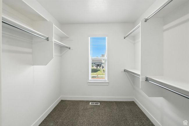 Spacious closet with dark carpet | Image 21