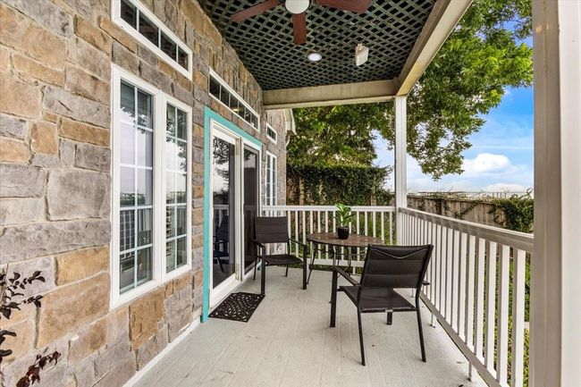 Covered ground floor porch also looks onto the pool and bay, and has a built in ceiling fan to add to the coastal breeze. | Image 26