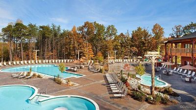 View of swimming pool with a community hot tub and a patio area | Image 2