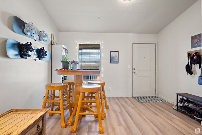 Dining area featuring light wood-style floors and baseboards | Image 9