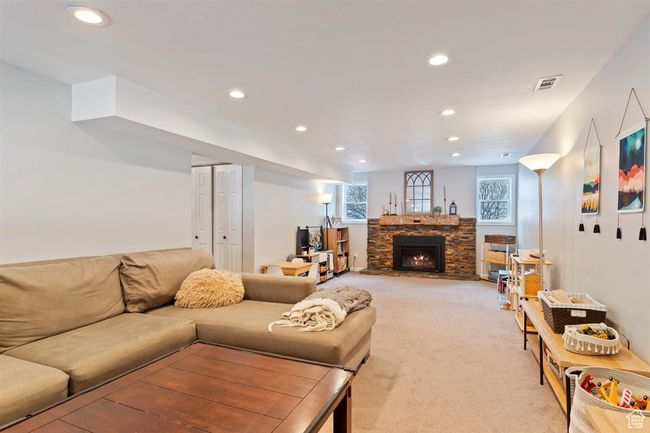 Living room featuring recessed lighting, light colored carpet, and a fireplace | Image 20