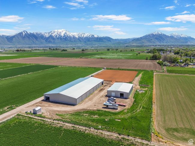 View of rural area featuring a mountain backdrop and rows of crops | Image 10