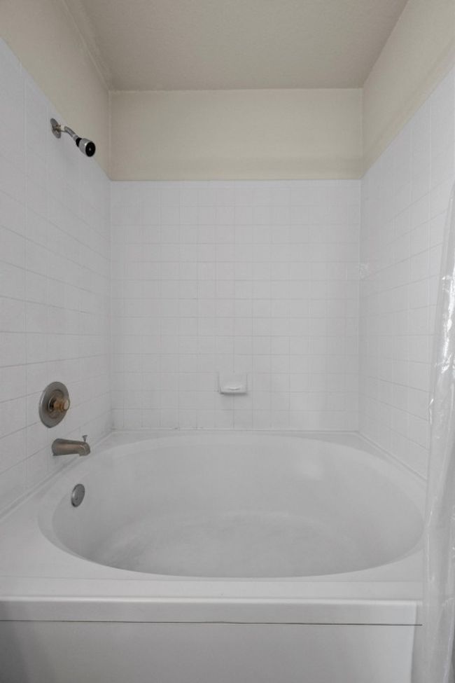 Bathroom featuring shower / bath combination with curtain | Image 19