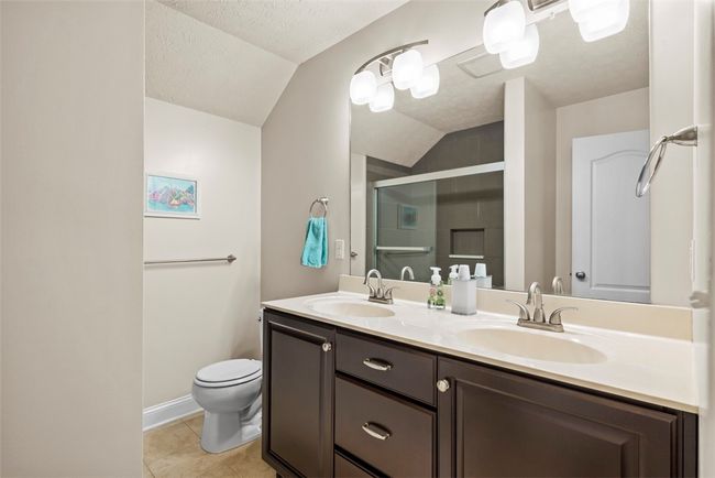 The guest bathroom has a dual vanity which is ideal for the shared space. | Image 34