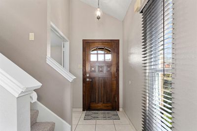 Tiled foyer entrance with a textured ceiling and vaulted ceiling | Image 3