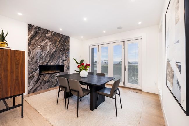 Dining room featuring recessed lighting, a premium fireplace, light wood-style floors, and visible vents | Image 18