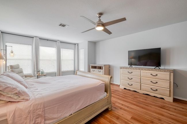 Bedroom featuring light wood-type flooring and ceiling fan | Image 20