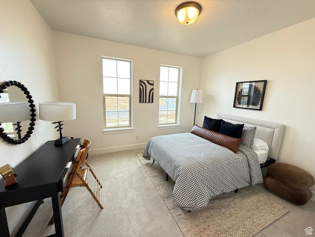 Bedroom featuring carpet, baseboards, and a textured ceiling | Image 8