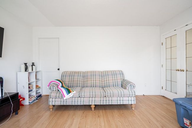 Living area with baseboards and wood finished floors | Image 13