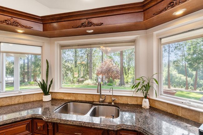 Who would mind doing dishes with this view of your own property!? Notice the Custom granite edges. | Image 8