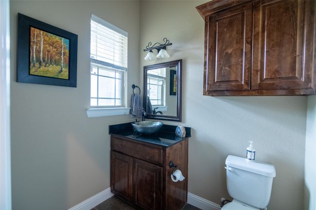 Half bath featuring vanity, toilet, and baseboards | Image 22