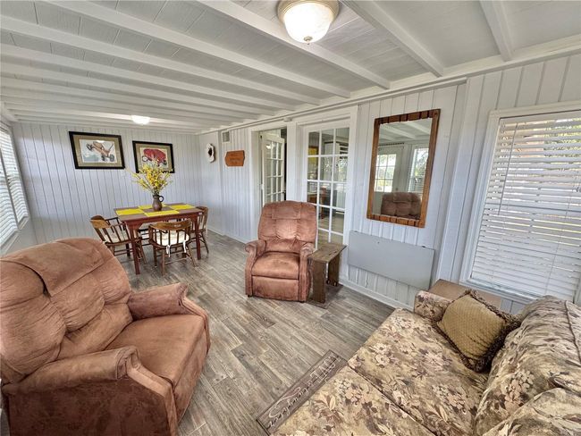 Front Florida room with a pull out couch for sleeping and chairs for sitting area and table/chairs eating area. Can be closed off for privacy. | Image 25