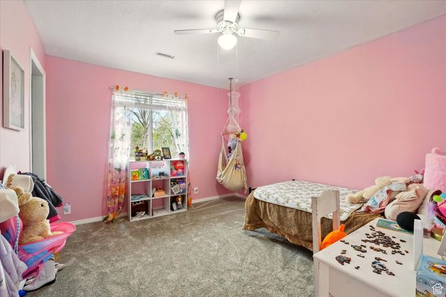Bedroom with carpet floors and ceiling fan | Image 36
