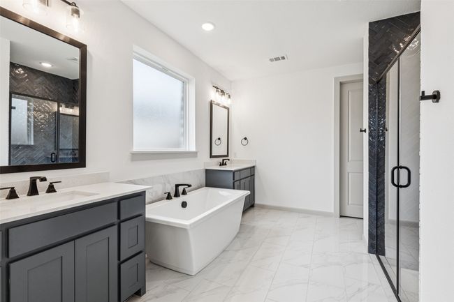 Featuring dual vanities with plenty of storage, this owner's bath offers plenty of room for two! | Image 12