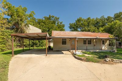 View of front facade featuring a front yard, a carport, and covered porch | Image 3