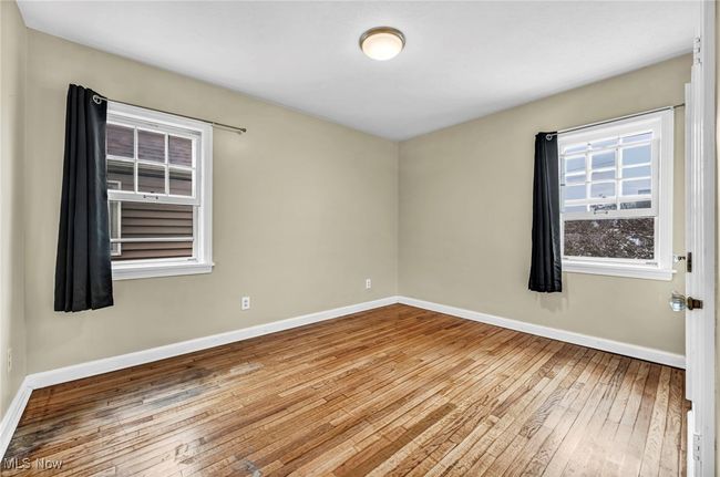 Empty room featuring baseboards and hardwood / wood-style flooring | Image 34