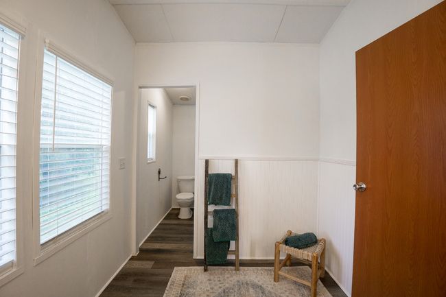 Bathroom with healthy amount of natural light, wood finished floors, and wainscoting | Image 20