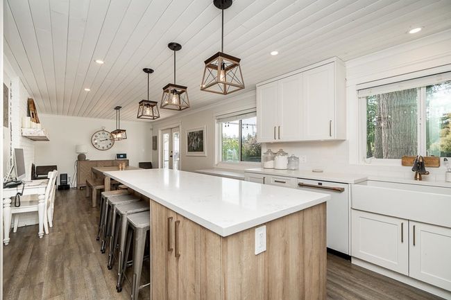 Kitchen with wooden ceiling, a healthy amount of sunlight, a center island, and recessed lighting | Image 8