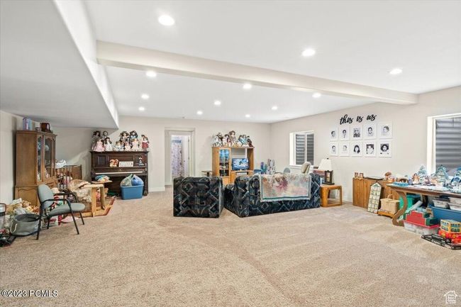 Carpeted living room featuring recessed lighting and beamed ceiling | Image 10