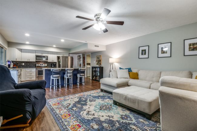 Living room with dark wood-style flooring, ceiling fan, and recessed lighting | Image 5