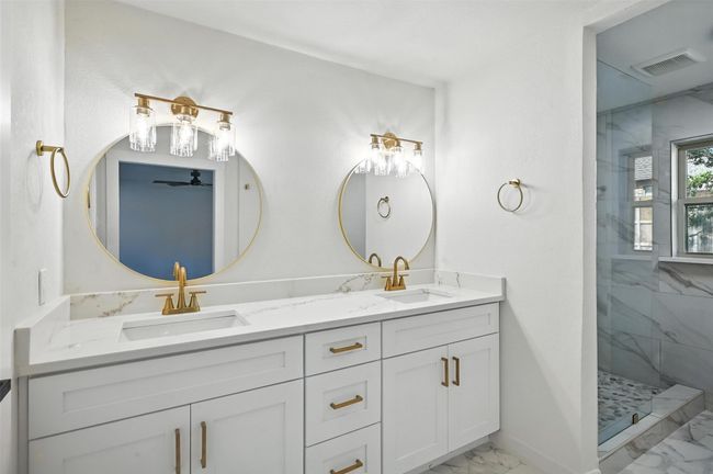 Primary bedroom is spacious with a walk in shower, 2 niches, dual vanities and a walk in closet. | Image 17
