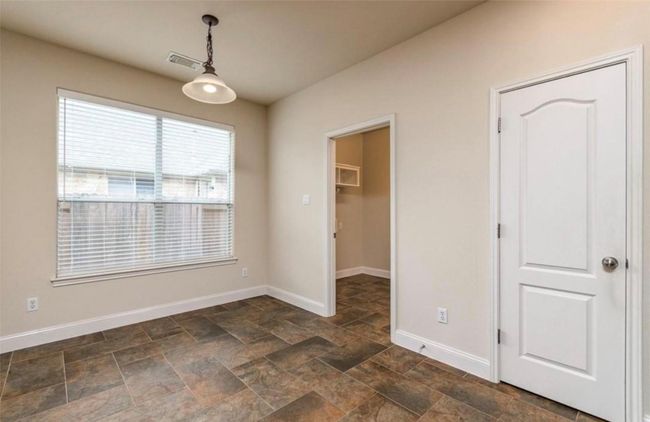 Unfurnished dining area featuring baseboards and stone finish floors | Image 9