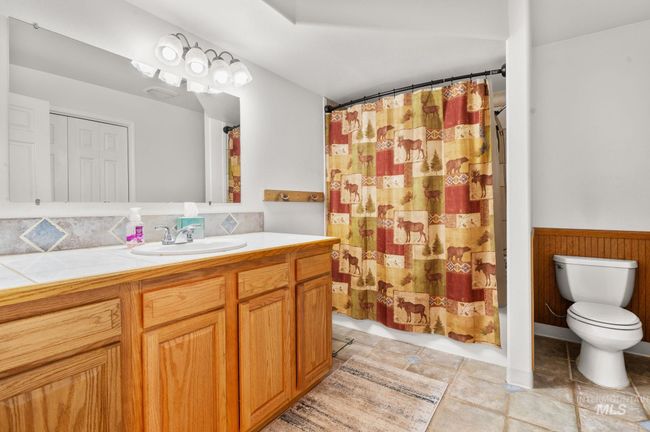 Lower level full Bathroom with vanity, a wainscoted wall, shower/bath combo with tiledfloors | Image 35