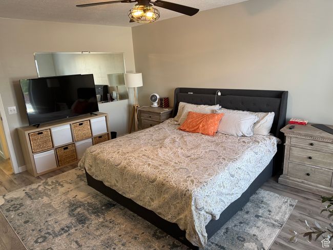 Bedroom with wood finished floors and ceiling fan | Image 19