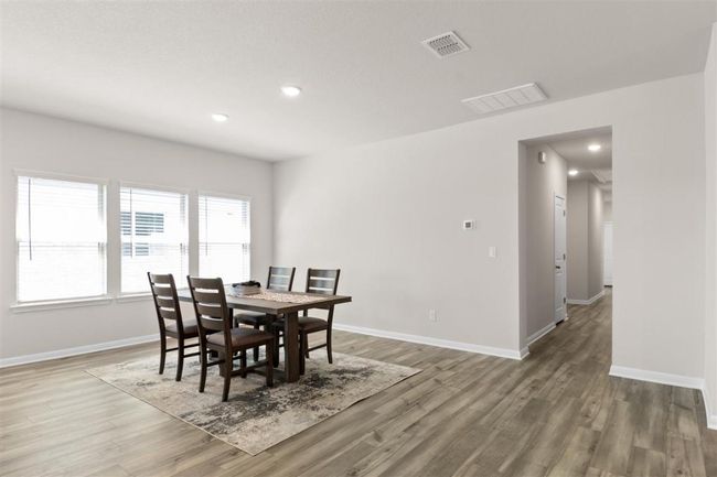 Dining space featuring baseboards, visible vents, and wood finished floors | Image 10