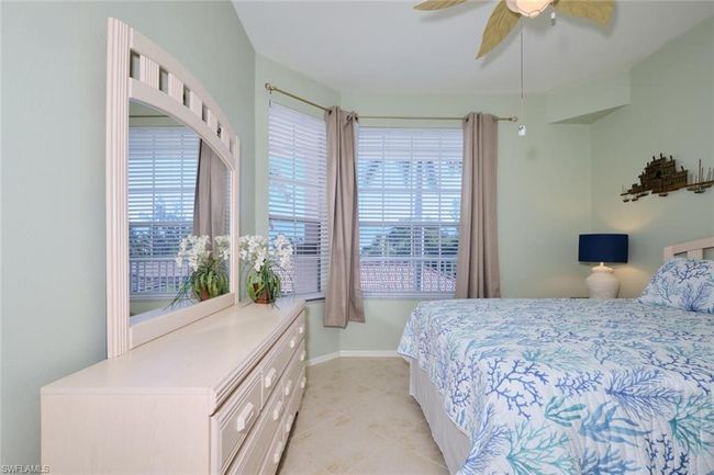 Bedroom featuring ceiling fan and light tile patterned floors | Image 42