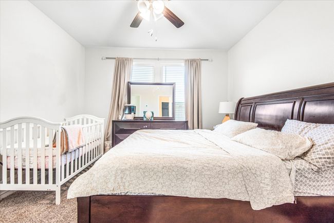 Bedroom with ceiling fan and carpet floors | Image 15