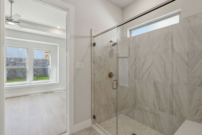 Full bathroom featuring a shower stall and a ceiling fan | Image 21