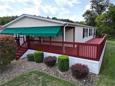 Spacious 3 Bedroom Ranch in Excellent Condition offering a Partially Covered Wraparound Deck & a Carport for 2 Vehicles! | Image 1