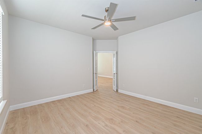 Unfurnished room featuring light wood-style floors and a ceiling fan | Image 21