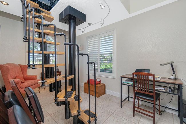 Spiral staircase goes up to a room where a large telescope existed before the owners bought the home | Image 34