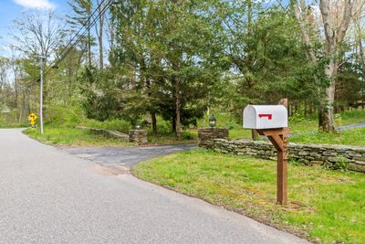 Grand Stone pillar along with impressive stone walls greet you at entrance to 52 Honey Hill | Image 2