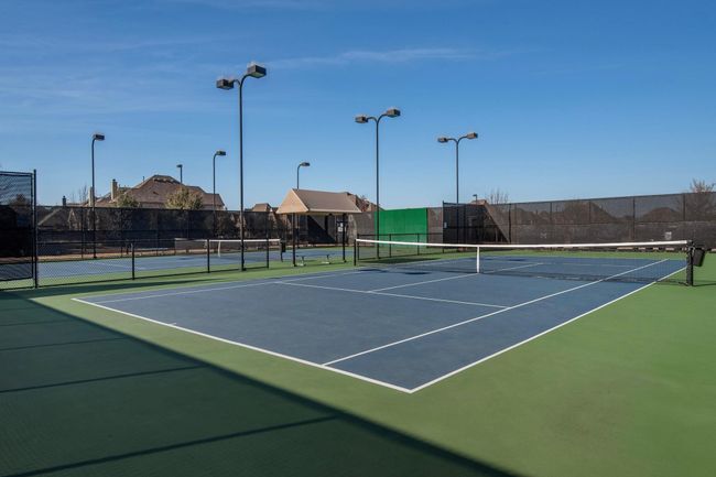 View of tennis court with fence and community basketball court | Image 19