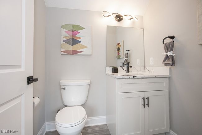 Bathroom with wood-type flooring, toilet, and large vanity | Image 18