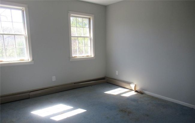 Unfurnished room featuring plenty of natural light and carpet | Image 6