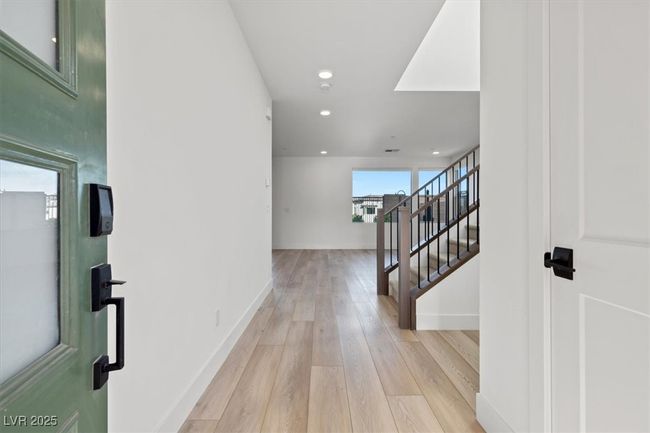 Entrance foyer with light wood finished floors, recessed lighting, stairs, and baseboards | Image 20