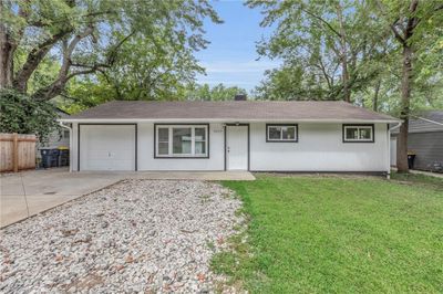 Ranch-style home with a garage and a front yard | Image 2