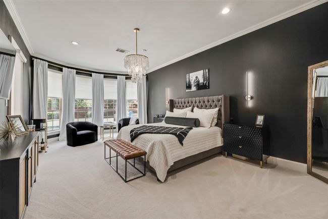 Large Primary Bedroom featuring light colored carpet, ornamental molding, a chandelier, and recessed lighting | Image 7