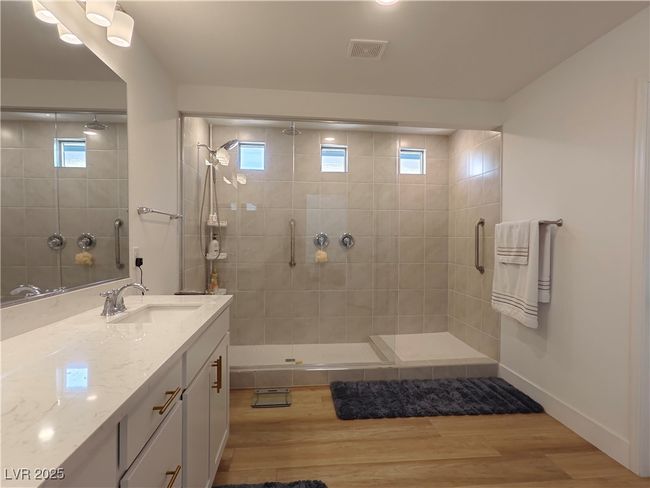 Full bathroom featuring visible vents, a stall shower, and wood finished floors | Image 36