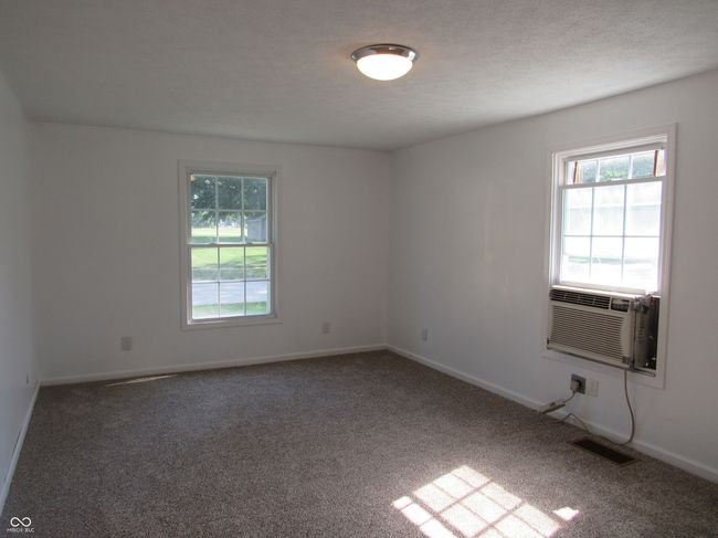 unfurnished room with carpet floors and cooling unit | Image 8