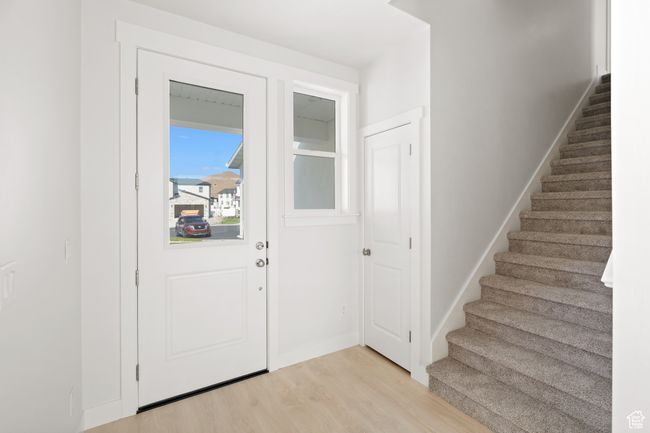 Foyer with light wood finished floors and stairs | Image 5