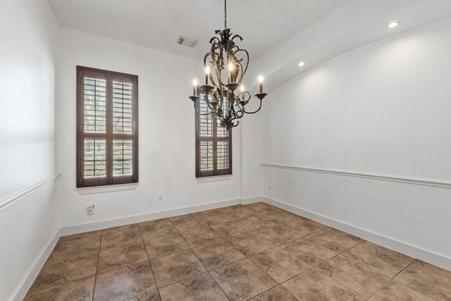 Tiled empty room featuring a chandelier and recessed lighting | Image 6