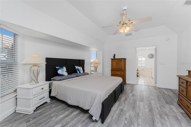 Primary Bedroom has a tray ceiling and ceiling fan | Image 23