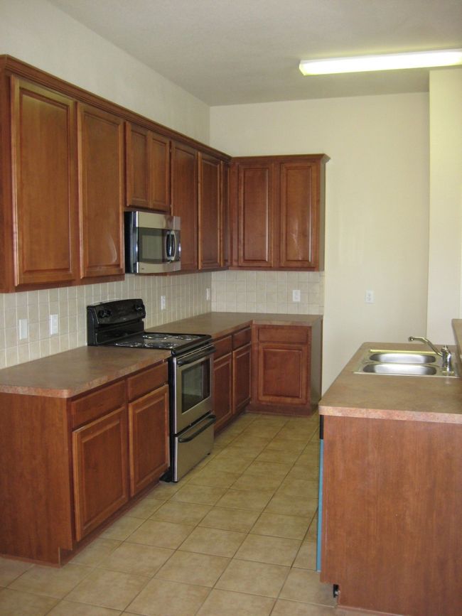 Kitchen featuring stainless steel appliances, tasteful backsplash, and light tile patterned floors | Image 7