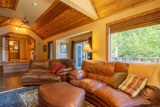 Living room featuring vaulted wooden ceiling with fan | Image 11