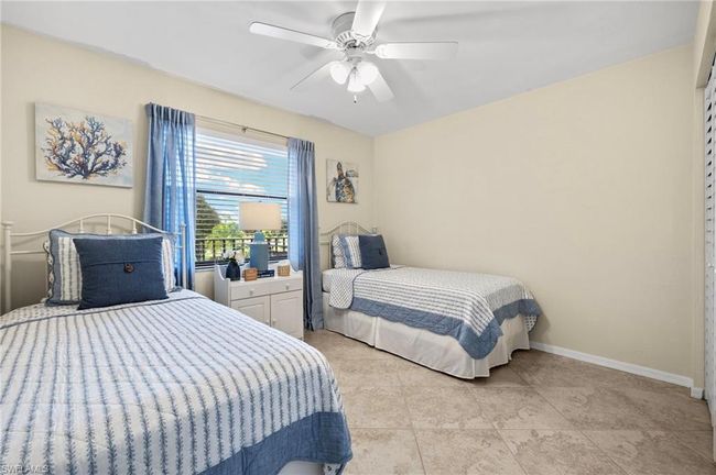 Bedroom with ceiling fan and light tile patterned flooring | Image 18